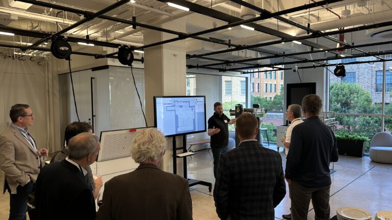 A presenter explains a connected-technology demonstration.